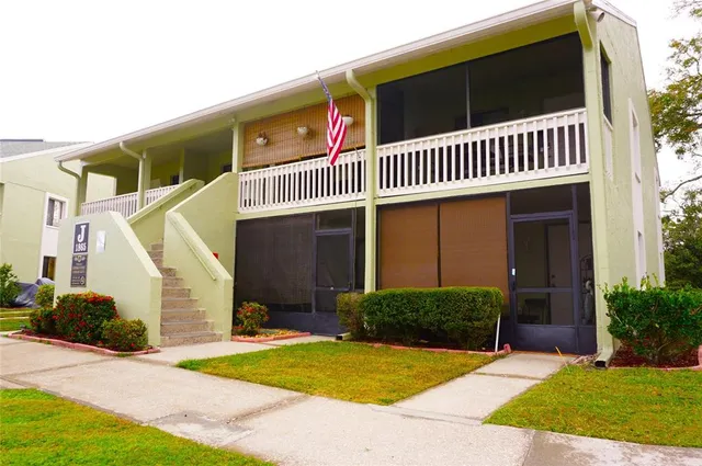 an aerial view of a house with a yard and lake view
