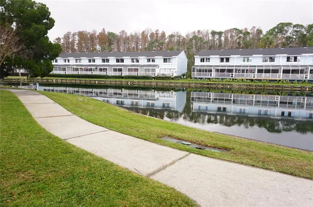 a front view of a house with a garden and a tree