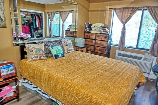 a bedroom with a bed and a window