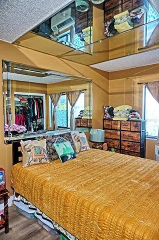 a bed sitting in a bedroom next to a window
