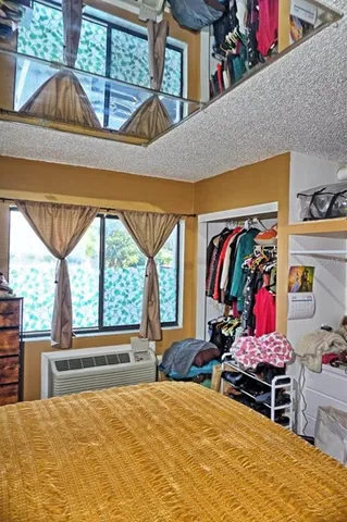 a bedroom with furniture and window