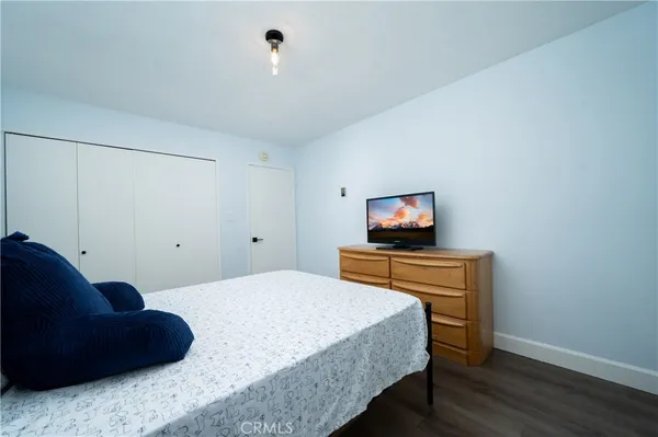 a bedroom with a bed and a television in it