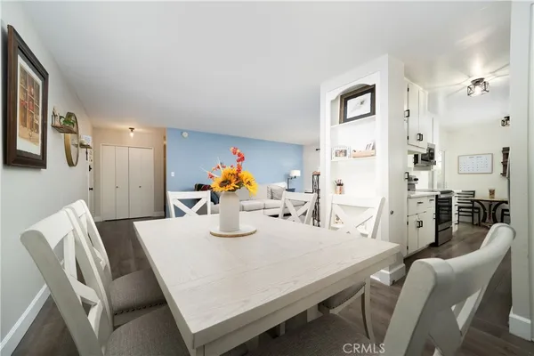 a dining room with furniture and wooden floor