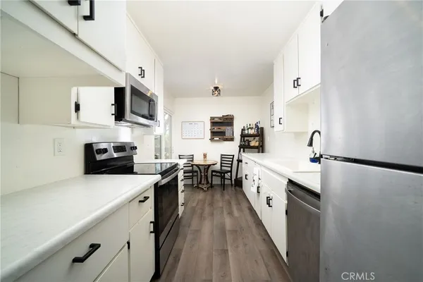 a kitchen with stainless steel appliances a sink dishwasher stove and refrigerator