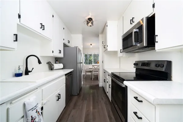 a kitchen with stainless steel appliances granite countertop a sink and a stove