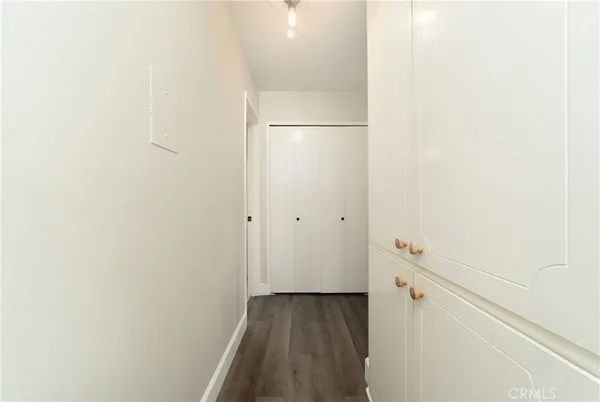 a view of a hallway with wooden floor