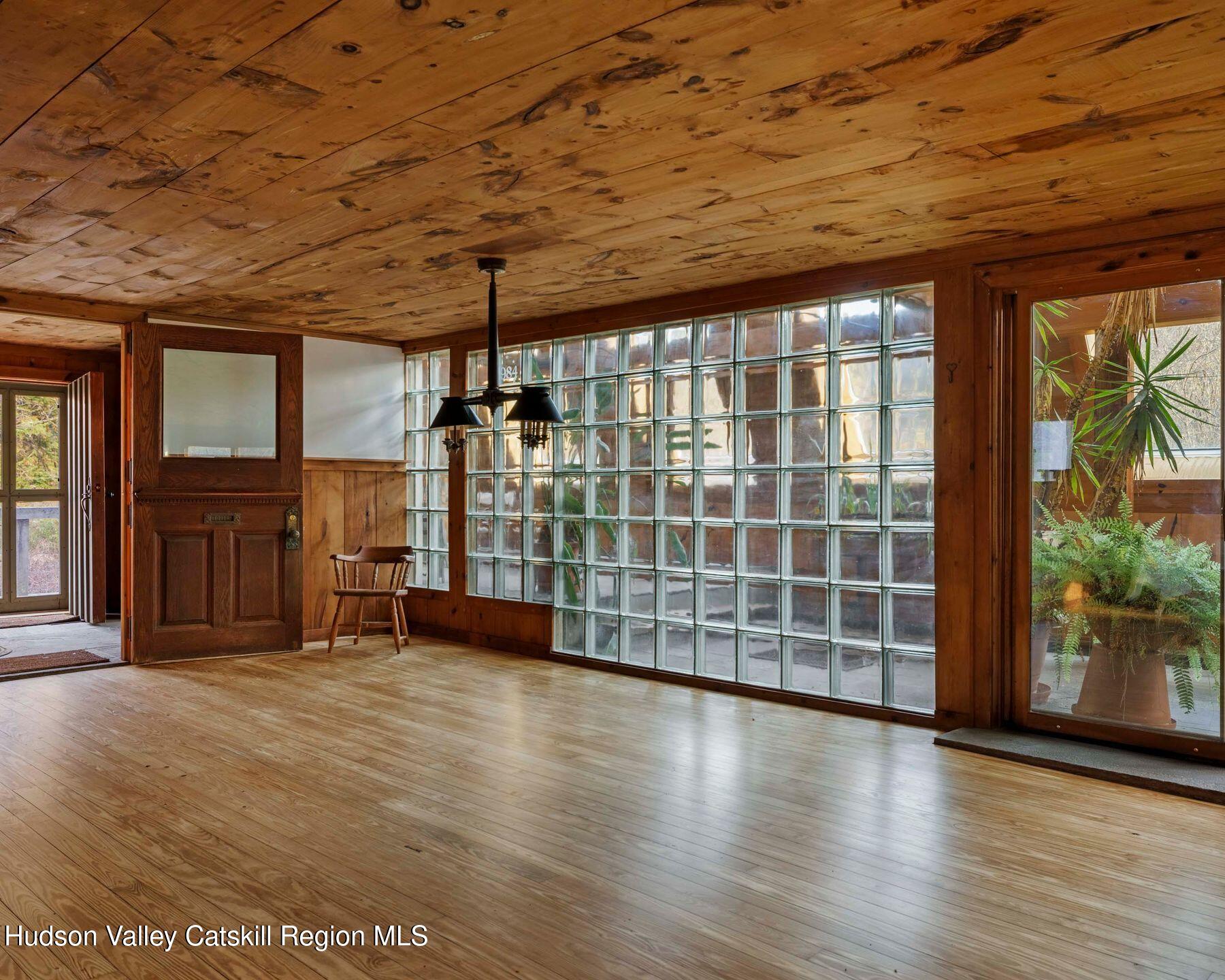 187 Beaver Hill Road Conesville, NY 12076 - Photo 24 of 79 an empty room with wooden floor and windows