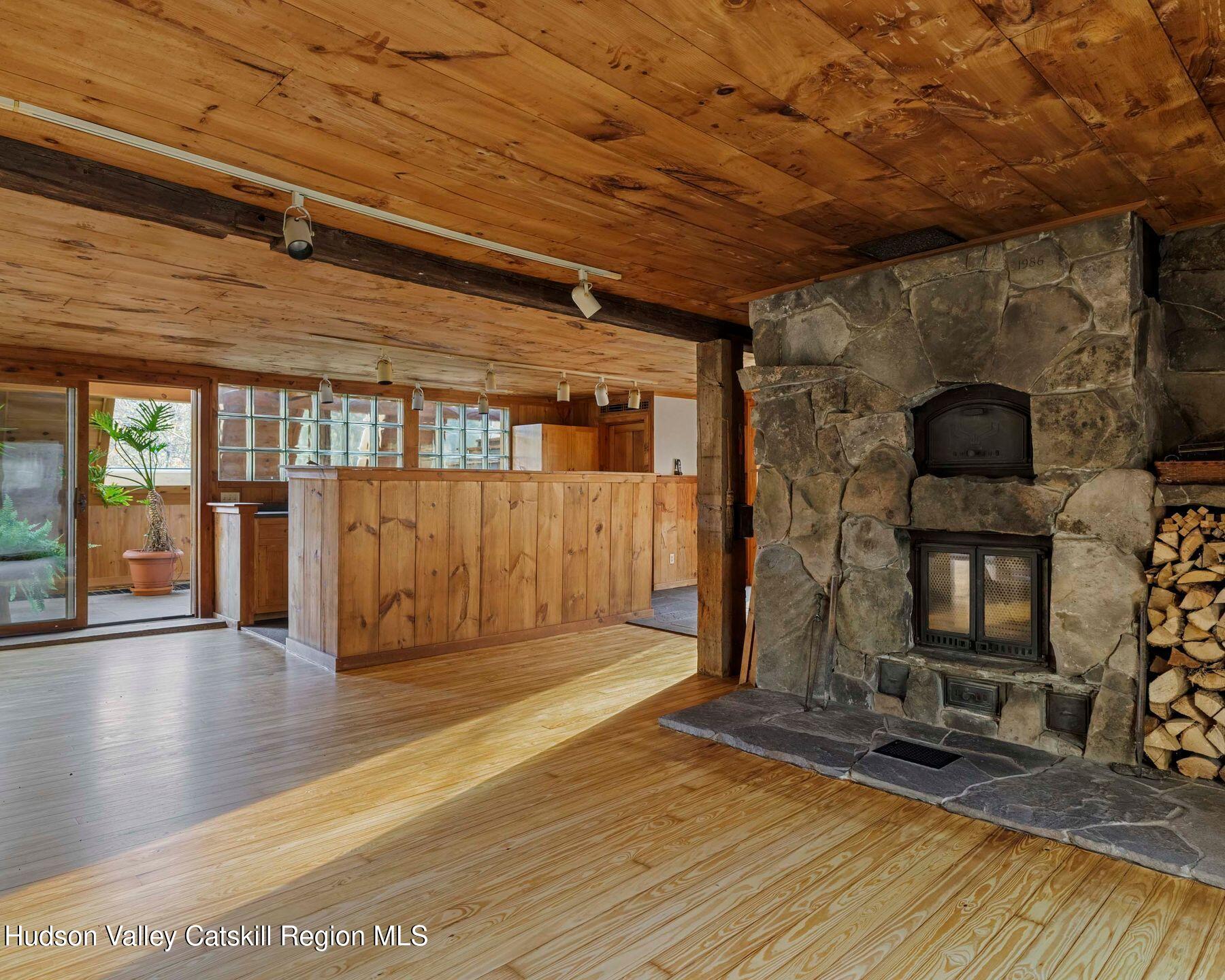 187 Beaver Hill Road Conesville, NY 12076 - Photo 29 of 79 a view of an empty room with wooden floor and a fireplace