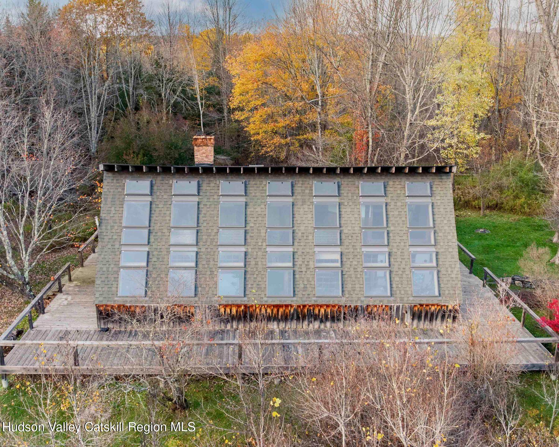 187 Beaver Hill Road Conesville, NY 12076 - Photo 3 of 79 a brick building with a bench in front of it