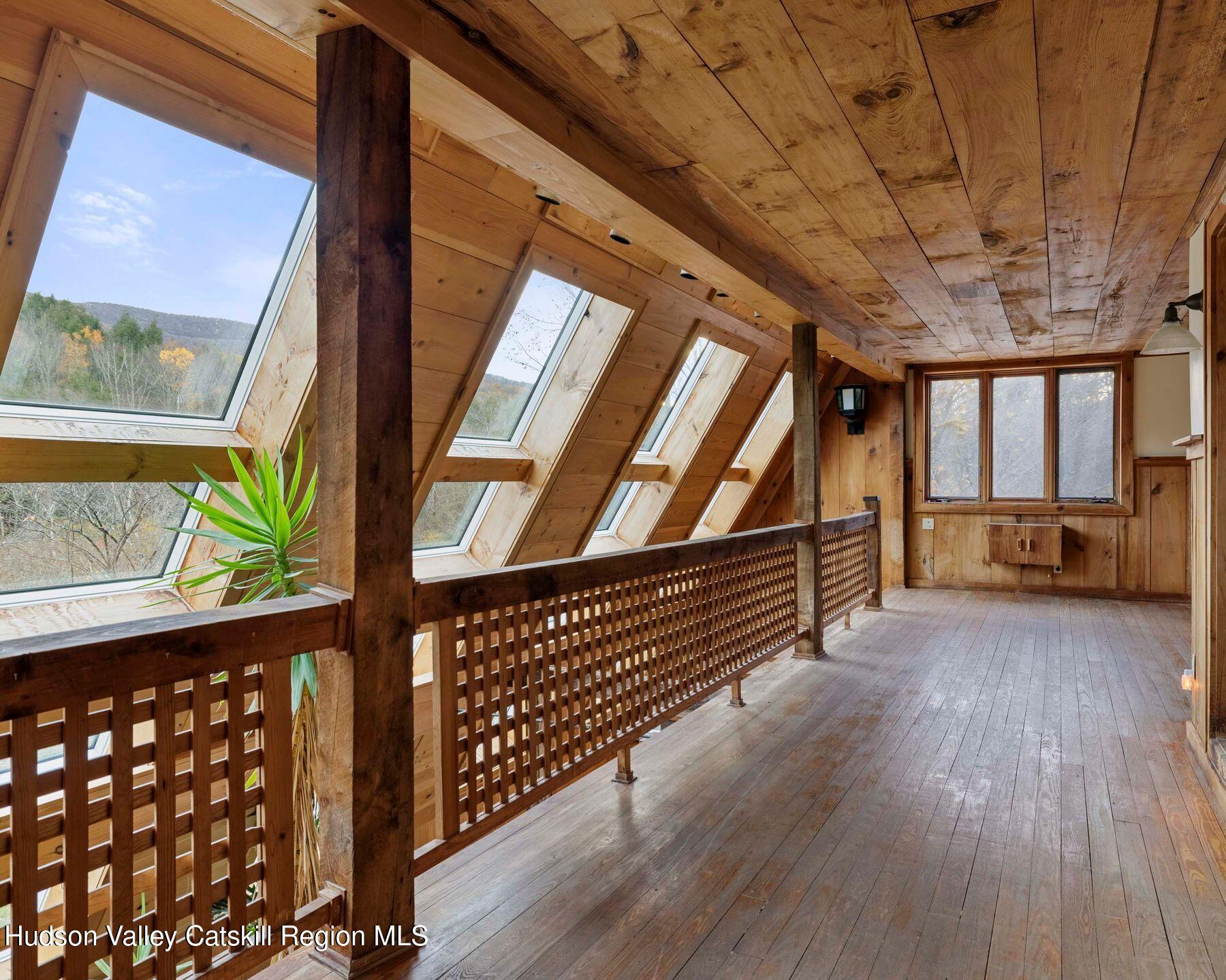 187 Beaver Hill Road Conesville, NY 12076 - Photo 45 of 79 a view of an empty room with wooden floor and windows