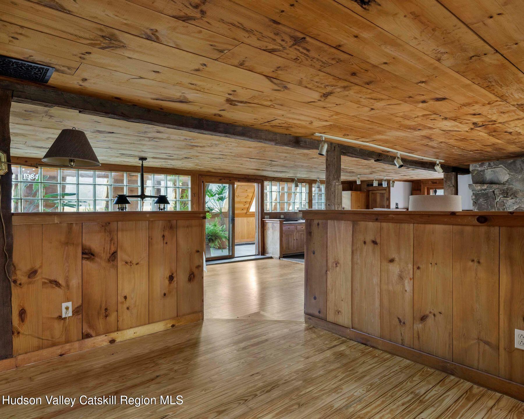 187 Beaver Hill Road Conesville, NY 12076 - Photo 63 of 79 an empty room with wooden floor and windows