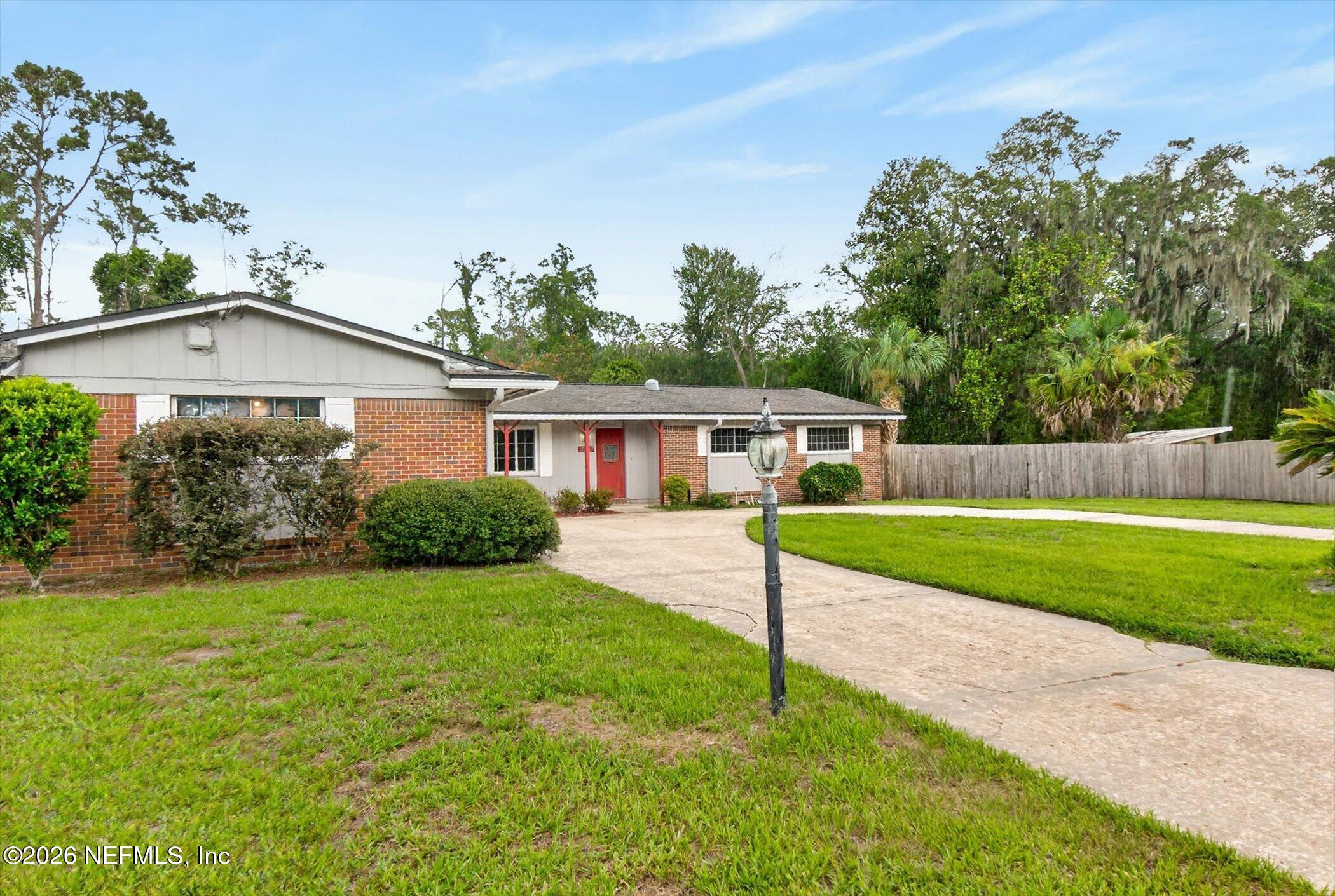 2705 Navajo Road Orange Park, FL 32073 - Photo 5 of 58 a front view of a house with a yard and trees