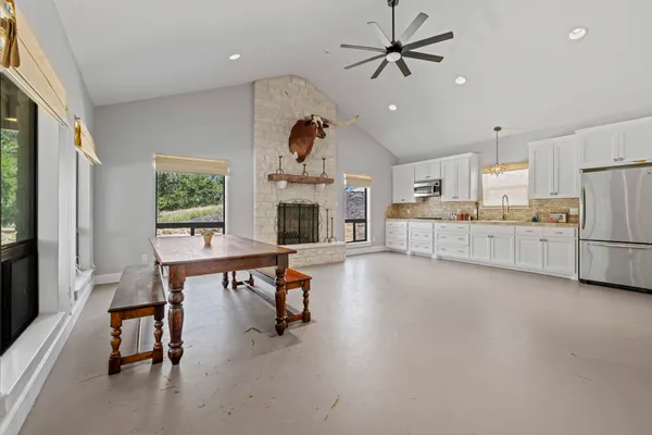 a kitchen with granite countertop cabinets and refrigerator