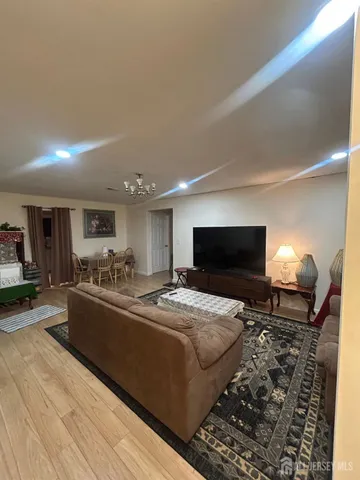 a large bedroom with a bed and a television on desk