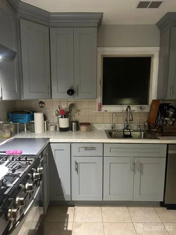 a kitchen with a sink stove and cabinets