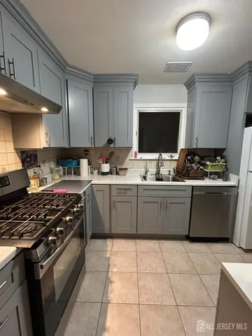 a kitchen with a stove a sink and a microwave