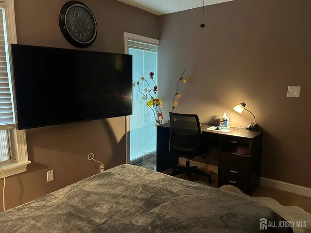 a bedroom with a bed and ceiling fan