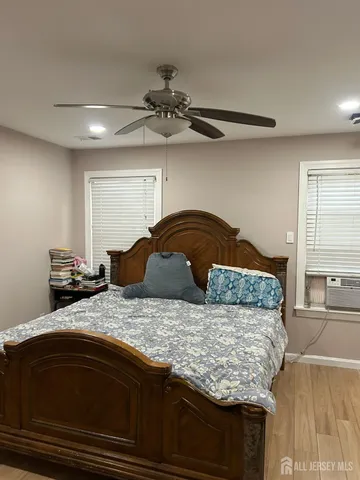 a bedroom with a bed and window