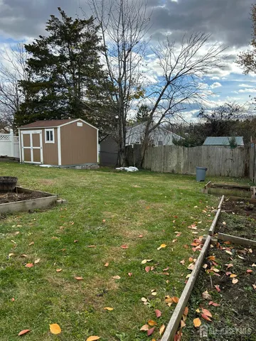 a view of a yard with wooden fence