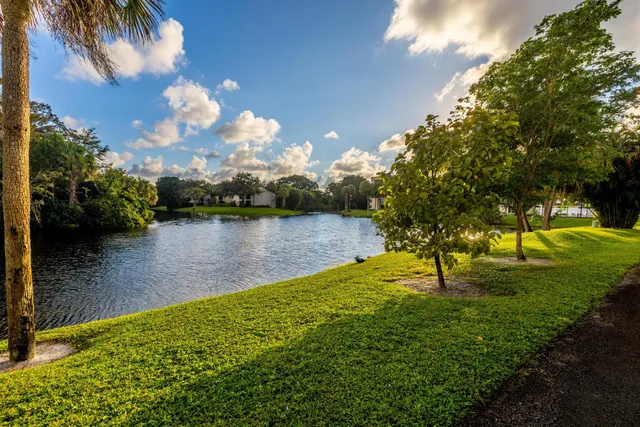 a front view of a multi story residential apartment building with a yard