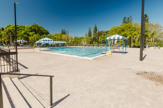 a view of swimming pool is middle in the garden