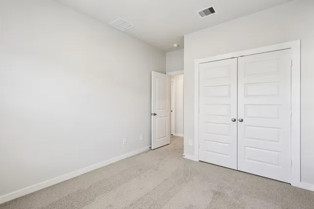 an empty room with closet area
