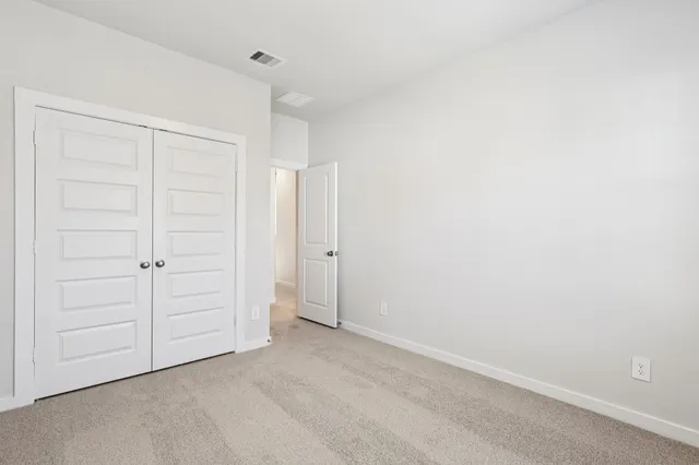 an empty room with closet area