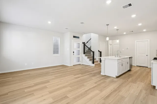 a view of a kitchen with furniture and a wooden floor