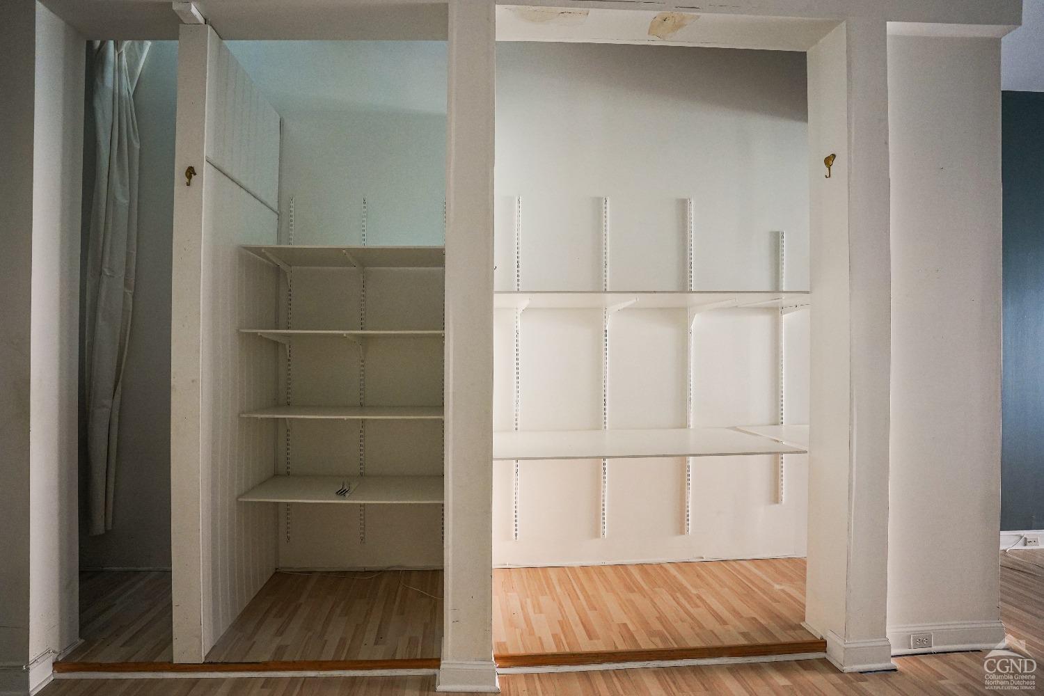 438 Warren Street Hudson, NY 12534 - Photo 14 of 21 a view of walk in closet with empty racks