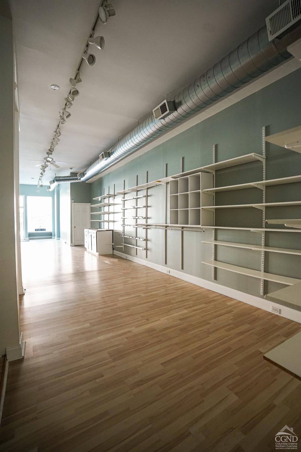 438 Warren Street Hudson, NY 12534 - Photo 16 of 21 a view of an empty room with wooden floor and a window