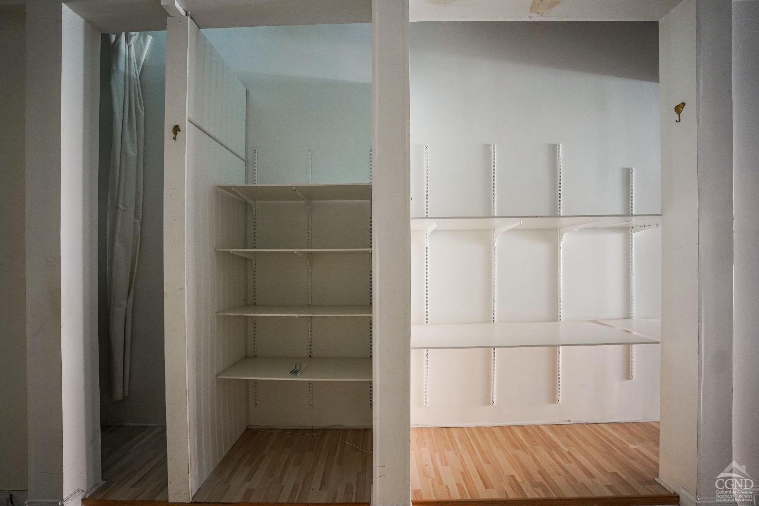 438 Warren Street Hudson, NY 12534 - Photo 9 of 21 a view of walk in closet with empty racks
