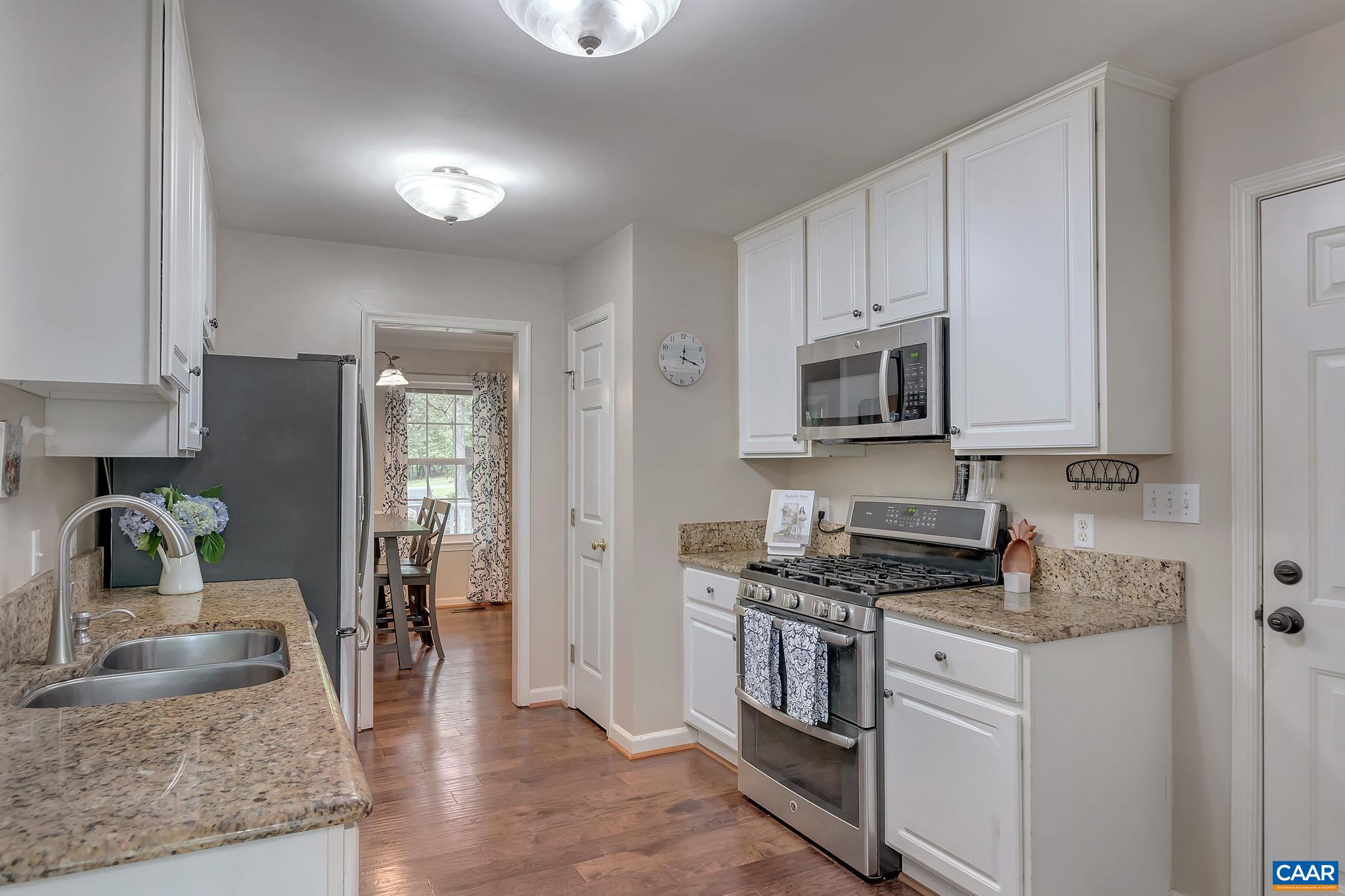 460 Northridge Road Ruckersville, VA 22968 - Photo 11 of 40 a kitchen with granite countertop a stove sink and microwave