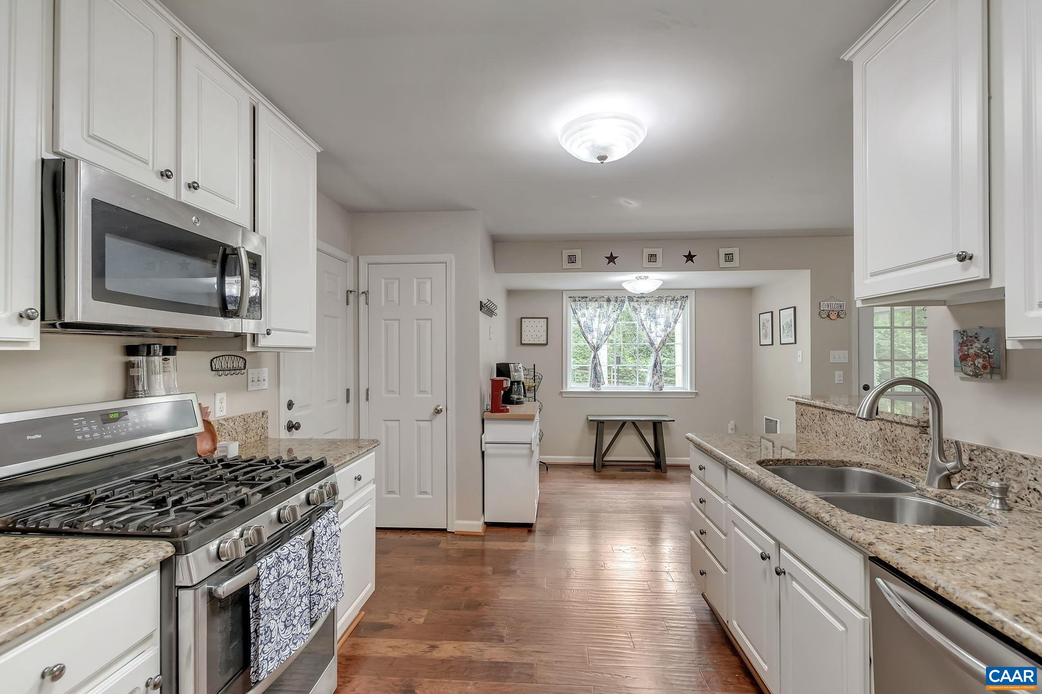 460 Northridge Road Ruckersville, VA 22968 - Photo 13 of 40 a kitchen with granite countertop a sink stove and cabinets