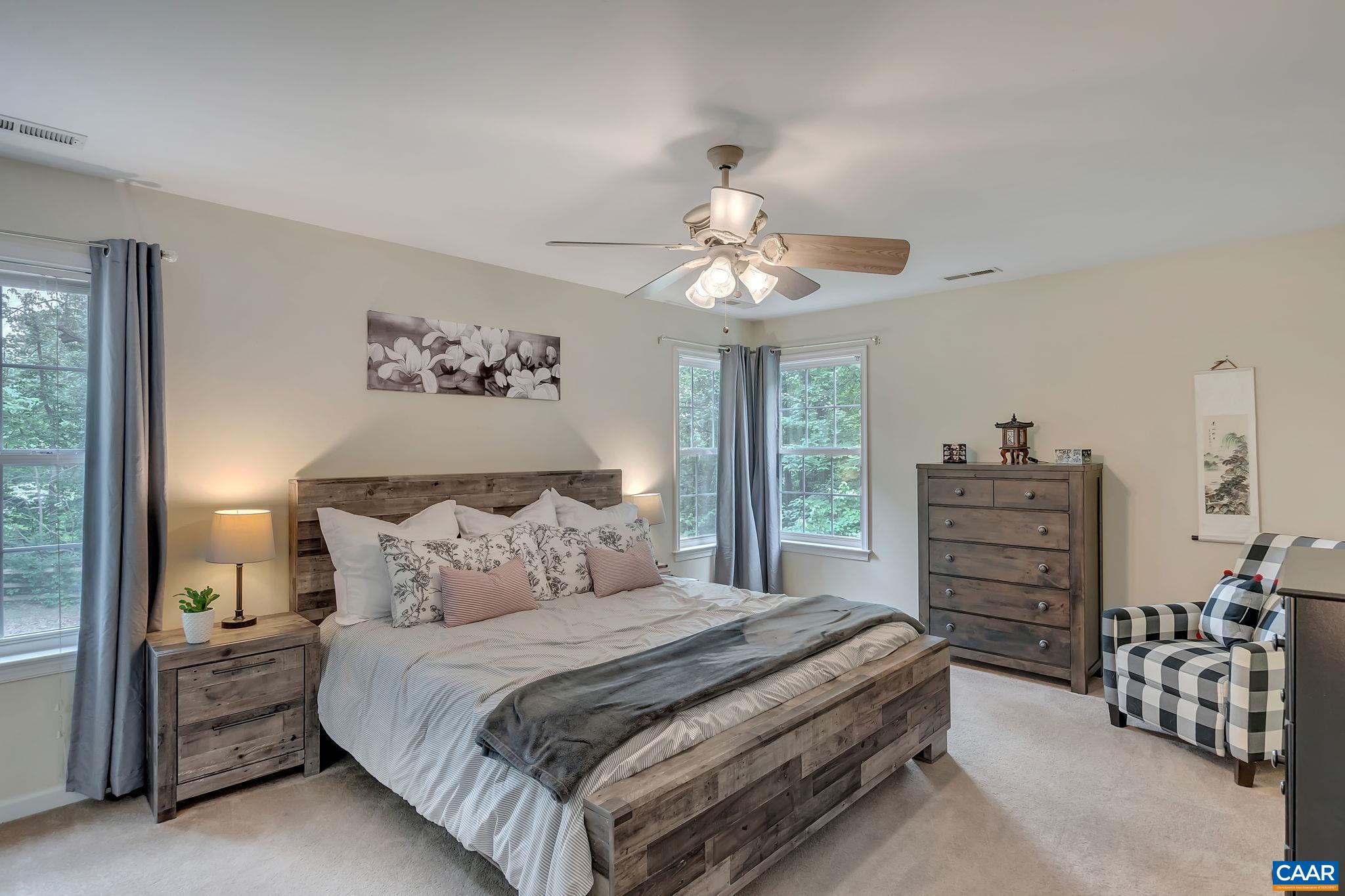 460 Northridge Road Ruckersville, VA 22968 - Photo 2 of 40 a bedroom with a bed and a chandelier