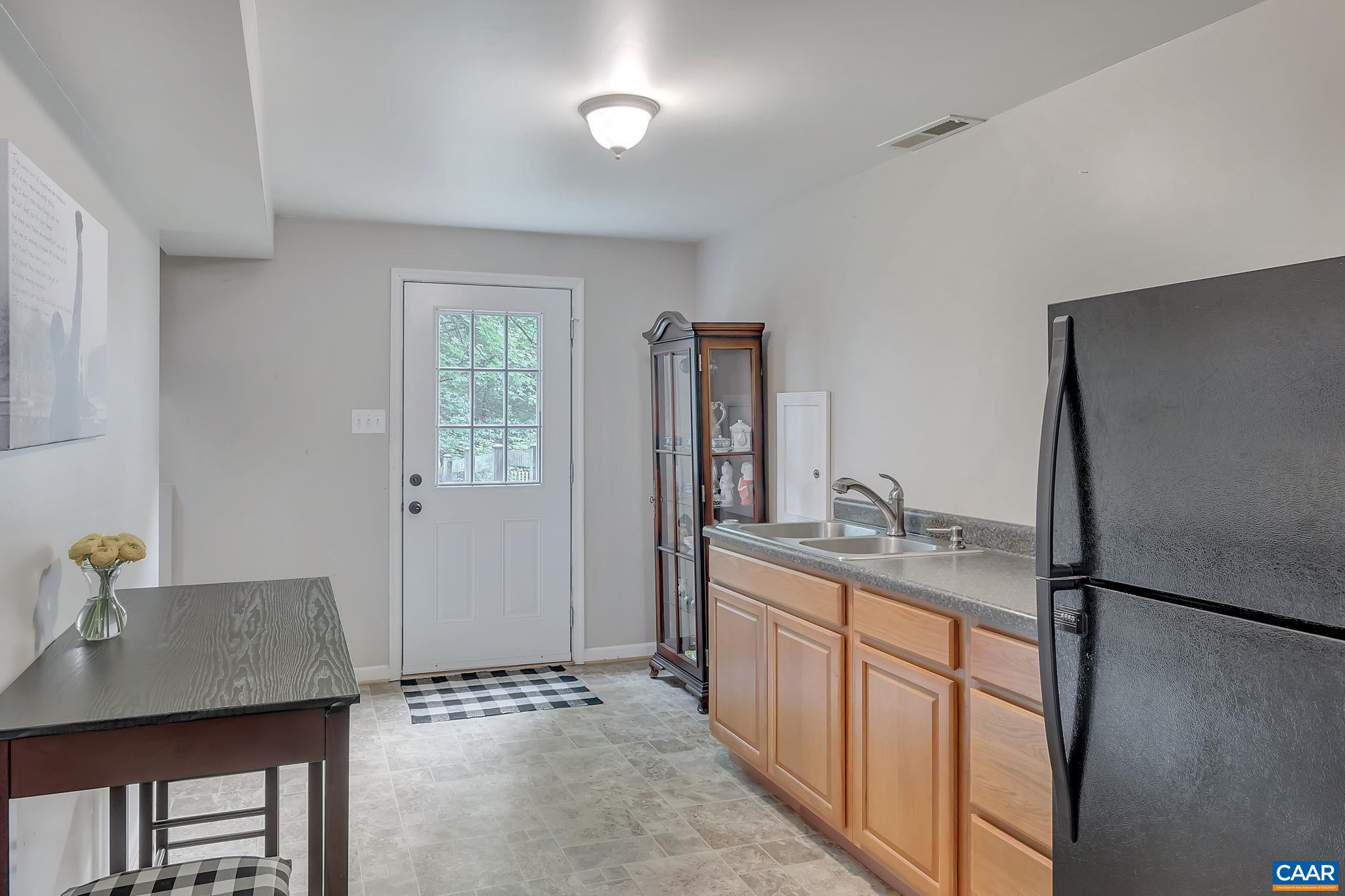 460 Northridge Road Ruckersville, VA 22968 - Photo 27 of 40 a kitchen with stainless steel appliances granite countertop a sink refrigerator and cabinets