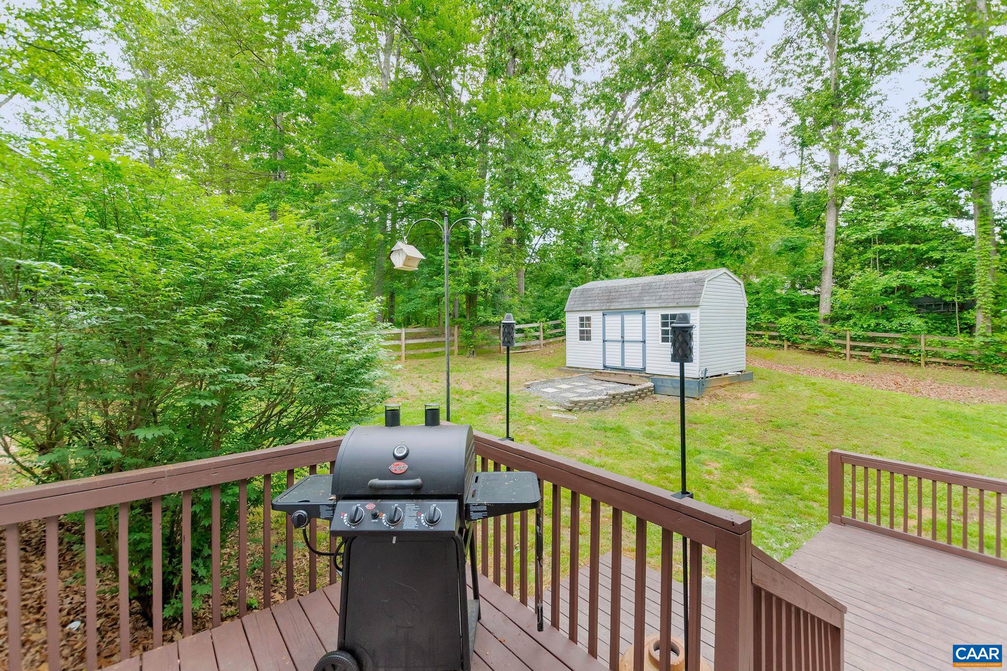 460 Northridge Road Ruckersville, VA 22968 - Photo 31 of 40 a view of a deck with two chairs and a yard