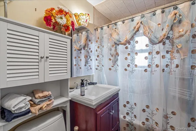 a bathroom with a sink vanity and a mirror