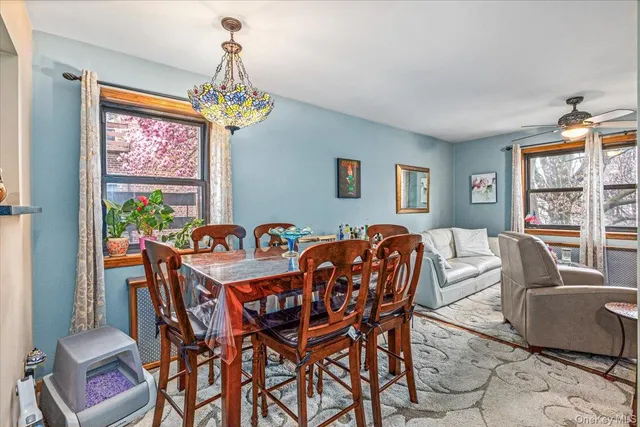 a dining room with furniture a chandelier and window