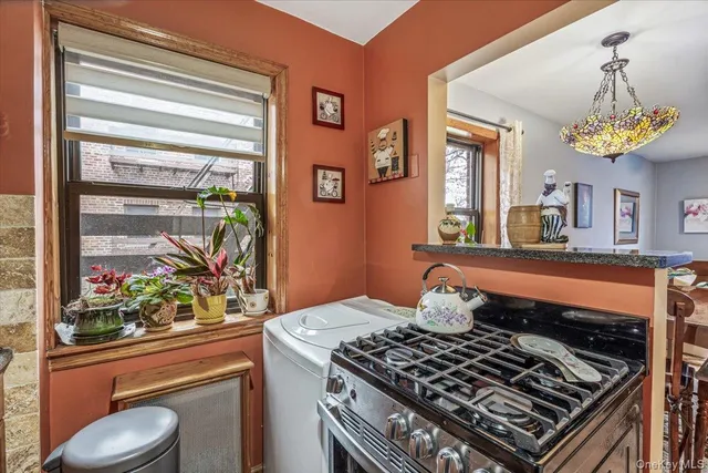 a kitchen with a stove and a window