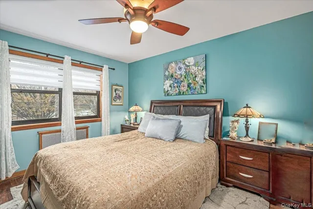 a bedroom with a large bed and a window