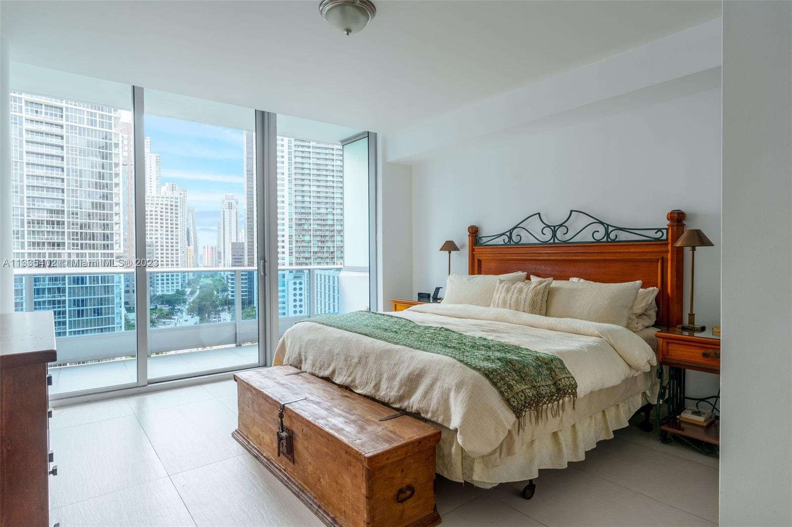 200 Biscayne Blvd Way, Unit 1404 Miami, FL 33131 - Photo 11 of 32 a bedroom with a large bed and a large window