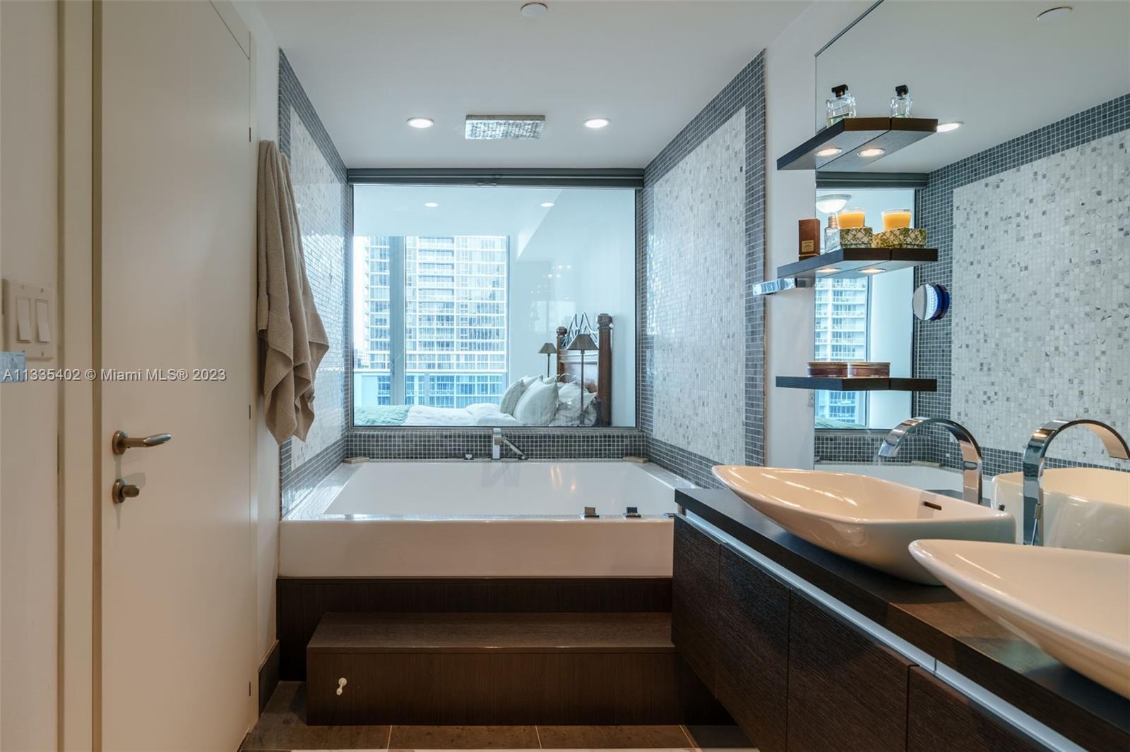 200 Biscayne Blvd Way, Unit 1404 Miami, FL 33131 - Photo 15 of 32 a bathroom with double vanity and a bathtub