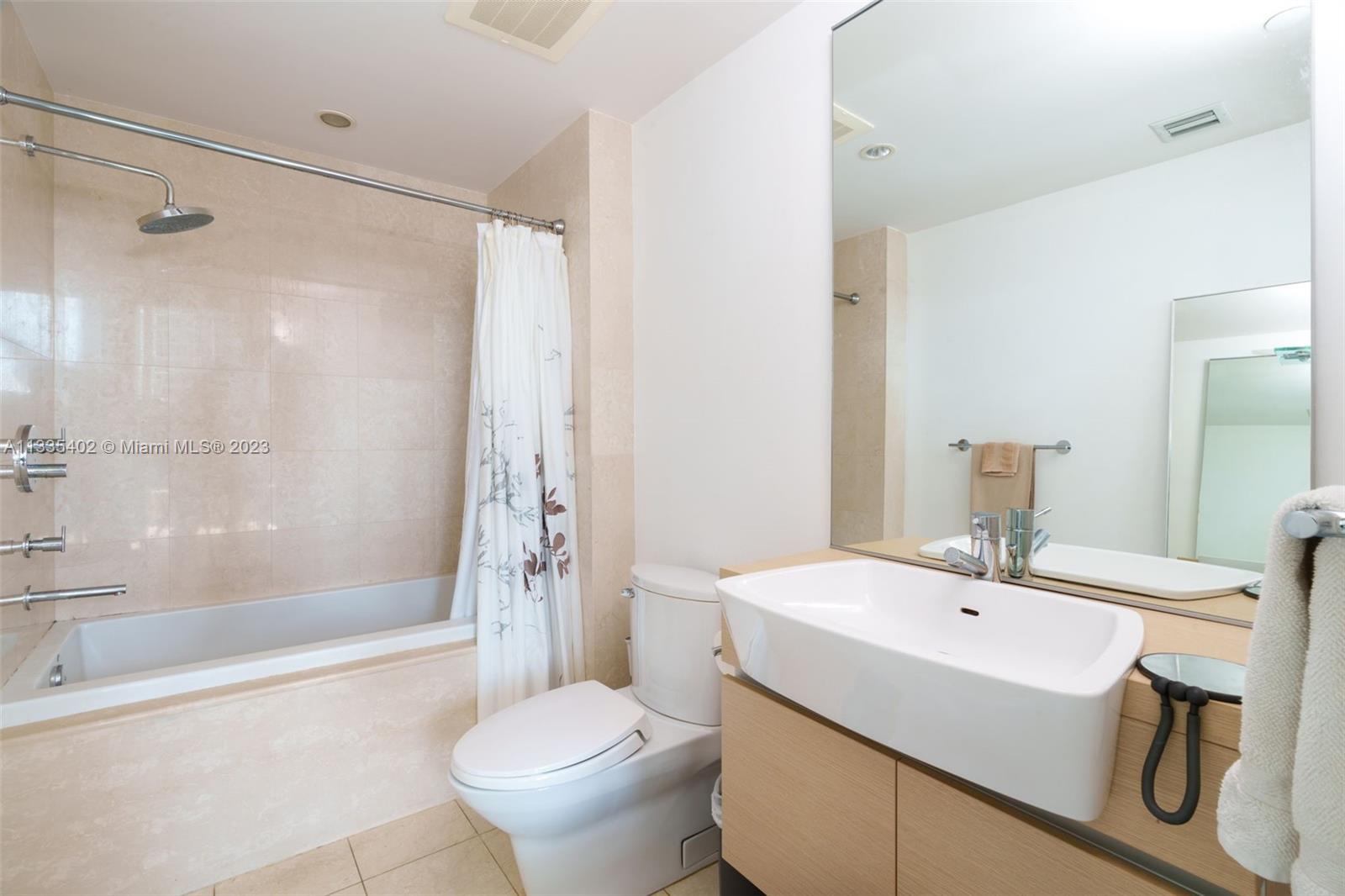 200 Biscayne Blvd Way, Unit 1404 Miami, FL 33131 - Photo 21 of 32 a bathroom with a sink toilet and shower