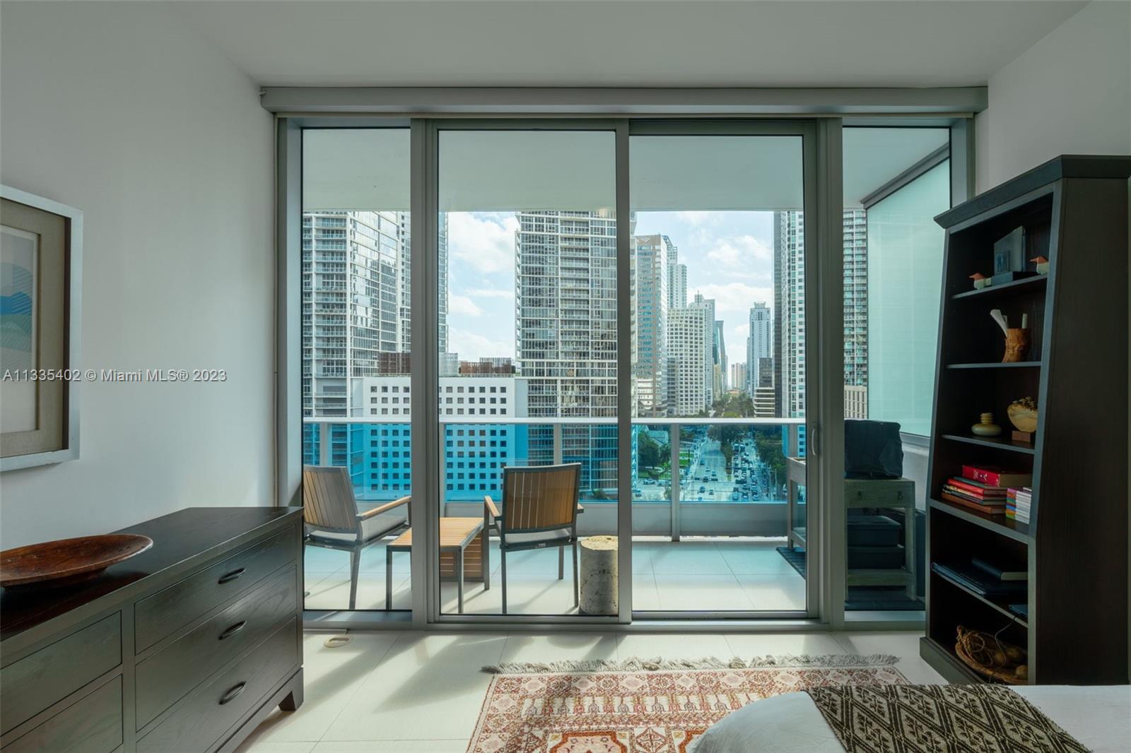 200 Biscayne Blvd Way, Unit 1404 Miami, FL 33131 - Photo 23 of 32 a living room with furniture and a floor to ceiling window