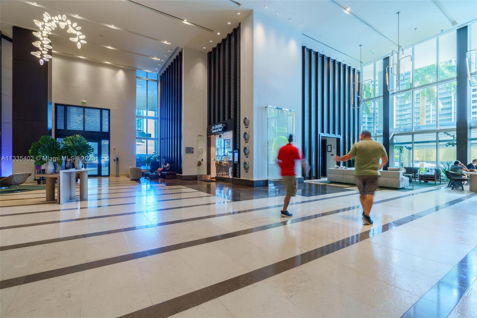200 Biscayne Blvd Way, Unit 1404 Miami, FL 33131 - Photo 30 of 32 a living room with furniture and potted plants