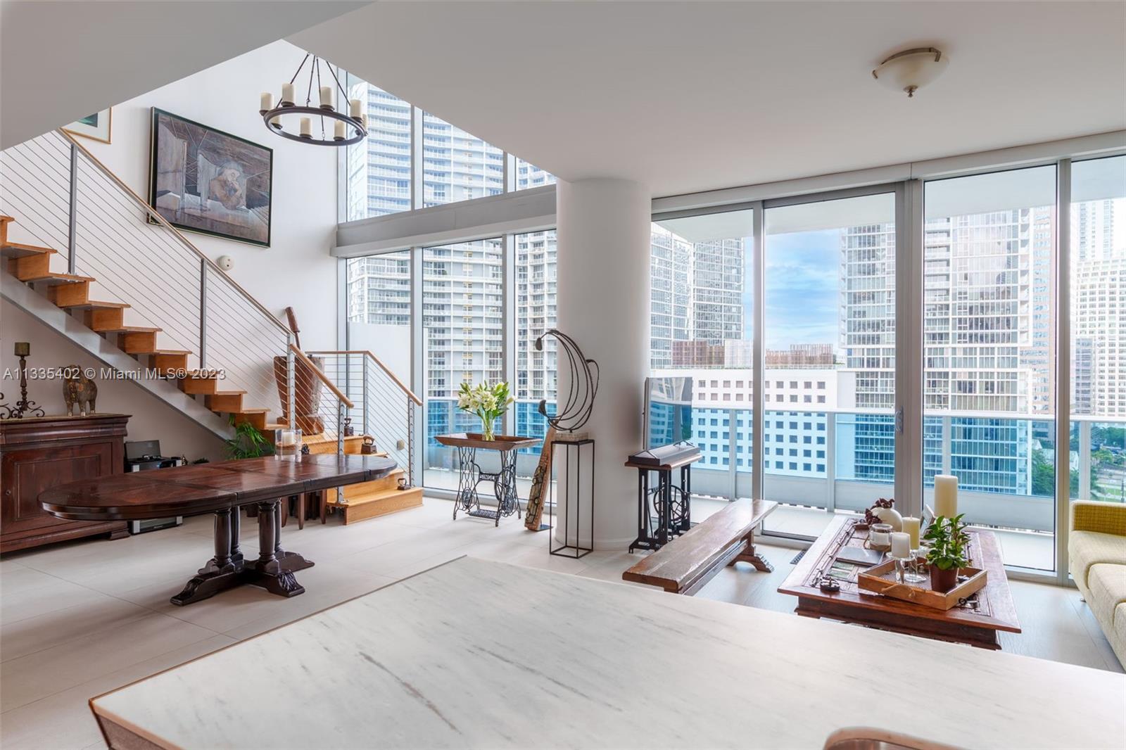 200 Biscayne Blvd Way, Unit 1404 Miami, FL 33131 - Photo 6 of 32 a living room with furniture and a floor to ceiling window