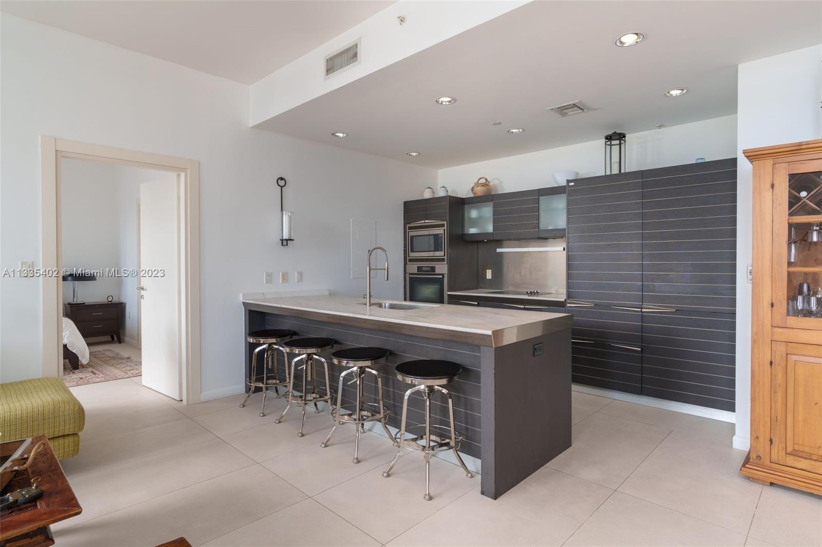 200 Biscayne Blvd Way, Unit 1404 Miami, FL 33131 - Photo 7 of 32 a kitchen with stainless steel appliances granite countertop a sink and a refrigerator