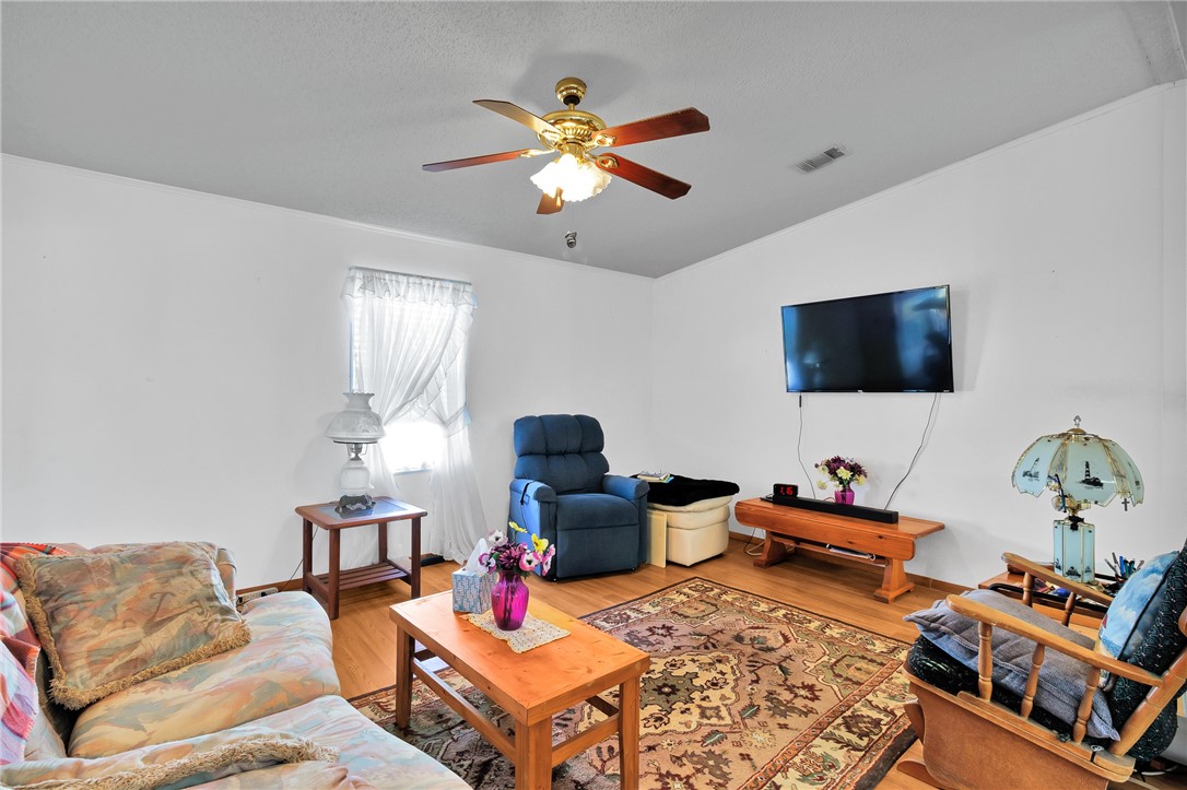 7571 Boxelder Road Micco, FL 32976 - Photo 11 of 36 a living room with furniture and a flat screen tv