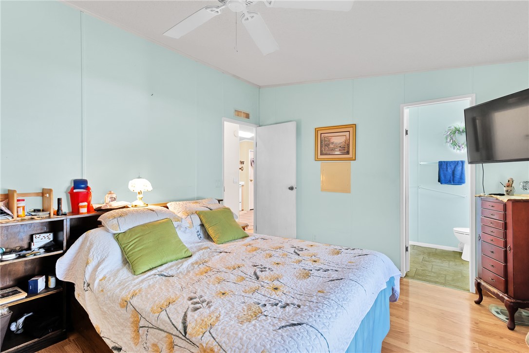 7571 Boxelder Road Micco, FL 32976 - Photo 15 of 36 a bedroom with a bed and a flat screen tv