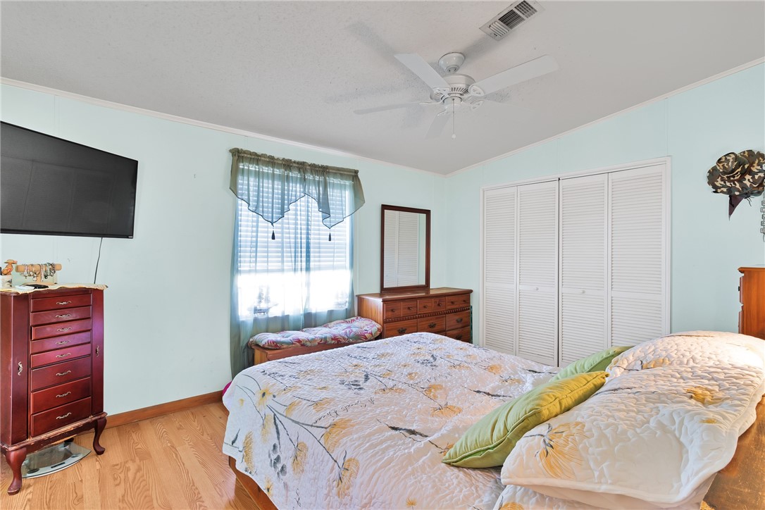 7571 Boxelder Road Micco, FL 32976 - Photo 16 of 36 a bedroom with a bed and a flat screen tv